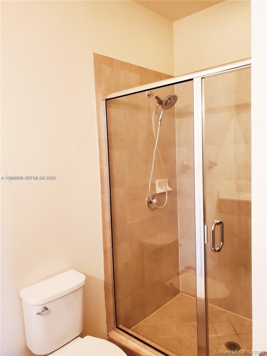3353 West 91st Terrace Hialeah, FL 33018 - Photo 10 of 21 a bathroom with a shower and a toilet