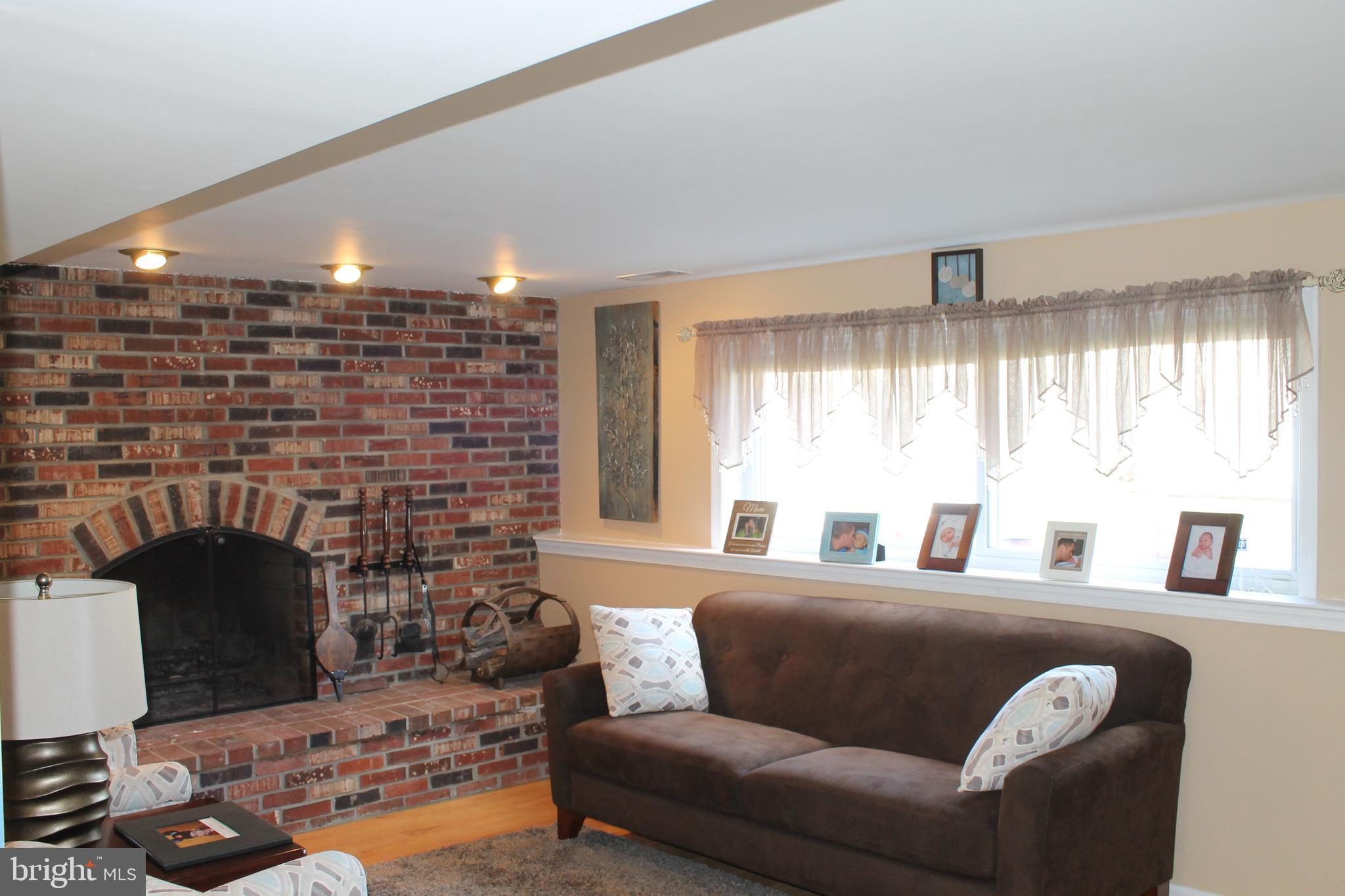 35 Overhill Road Stratford, NJ 08084 - Photo 2 of 43 a living room with furniture and a fireplace