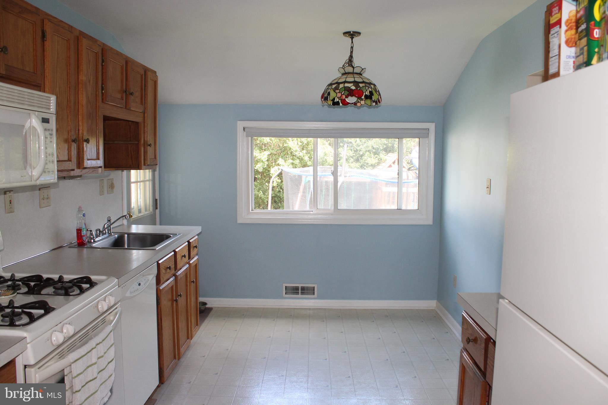 35 Overhill Road Stratford, NJ 08084 - Photo 13 of 43 a kitchen with a stove a sink and a window