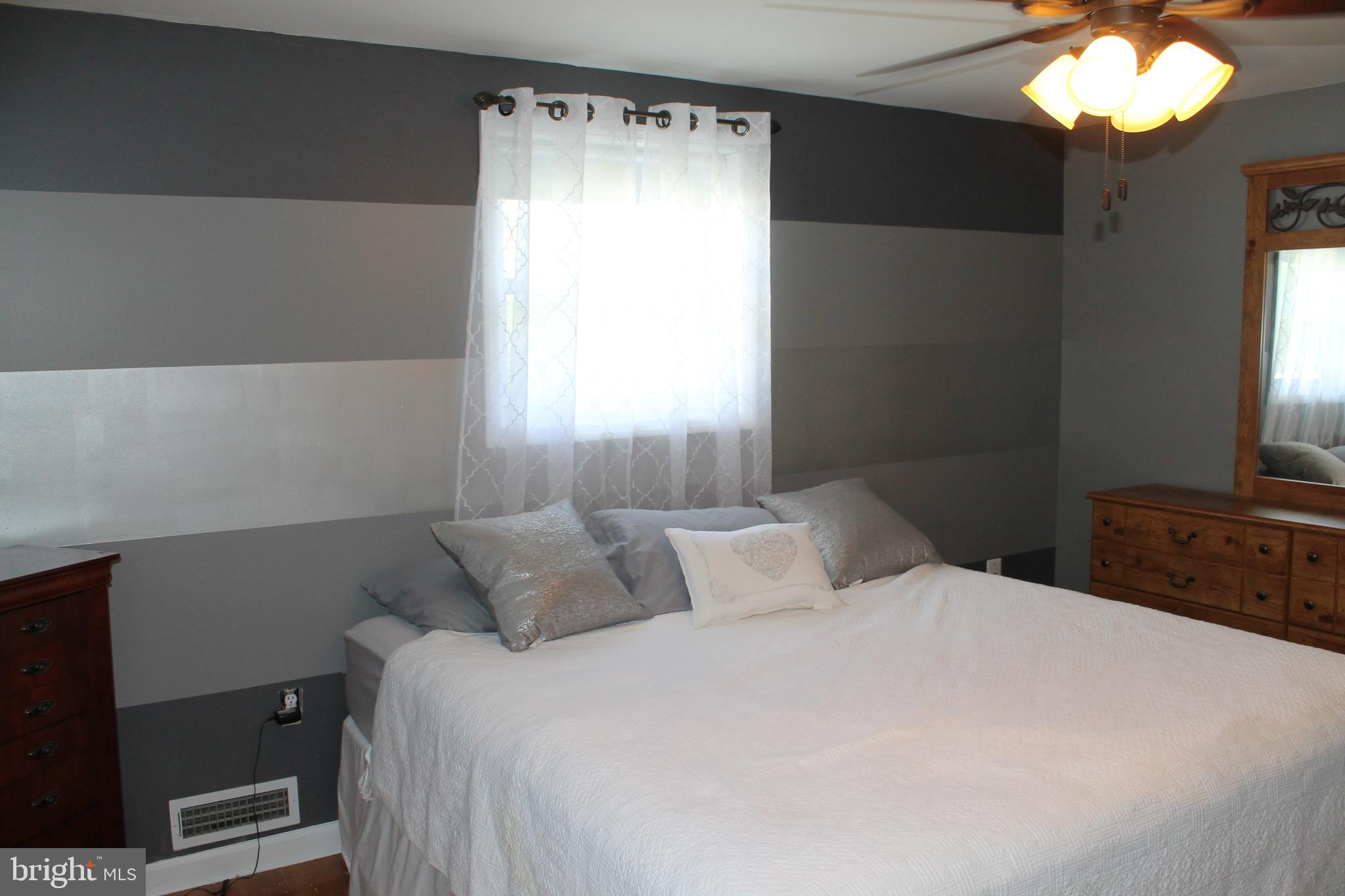 35 Overhill Road Stratford, NJ 08084 - Photo 17 of 43 a bedroom with a bed and a flat tv screen on dresser