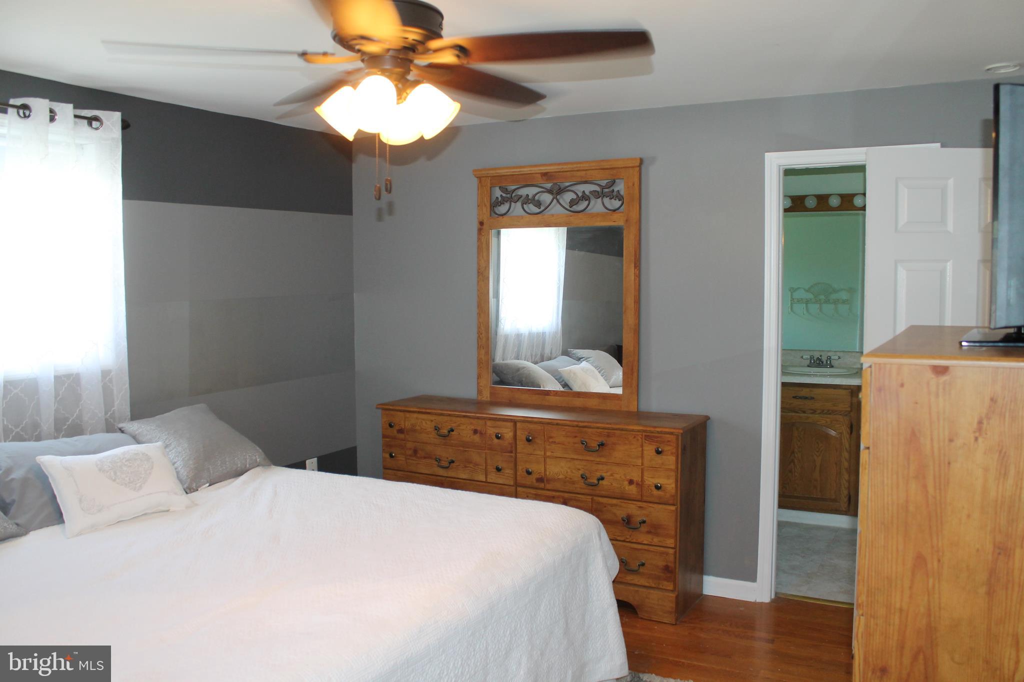 35 Overhill Road Stratford, NJ 08084 - Photo 18 of 43 a bedroom with a bed and a chandelier