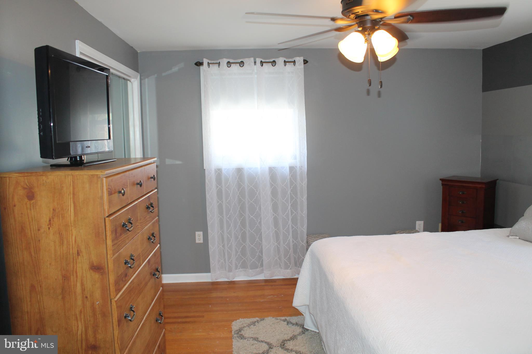 35 Overhill Road Stratford, NJ 08084 - Photo 19 of 43 a spacious bedroom with a bed and a flat screen tv