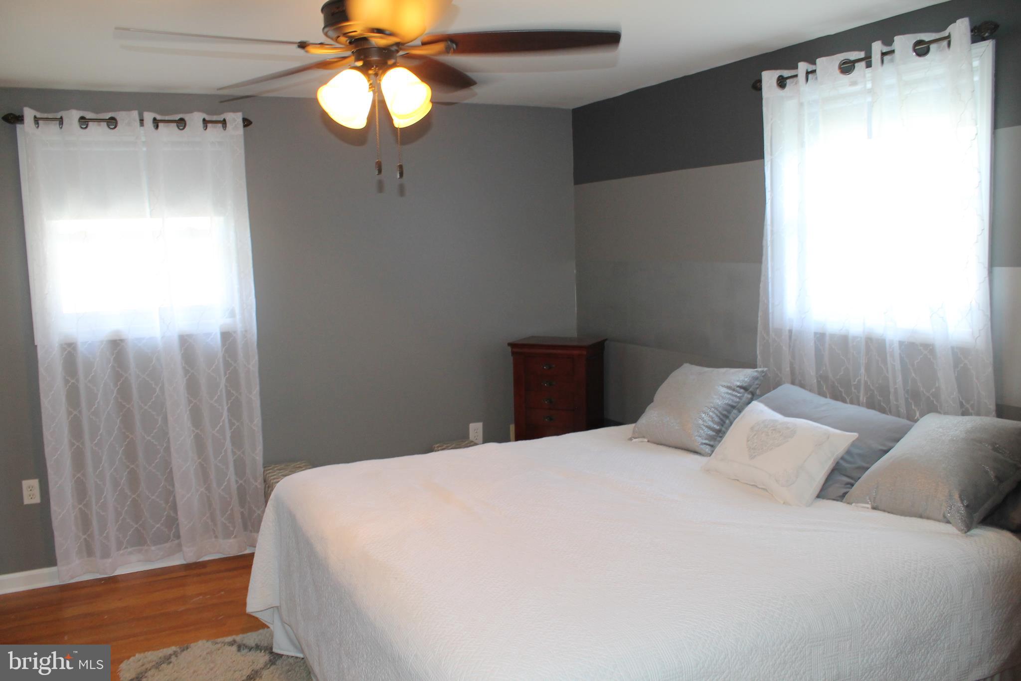 35 Overhill Road Stratford, NJ 08084 - Photo 20 of 43 a bedroom with a bed and a chandelier