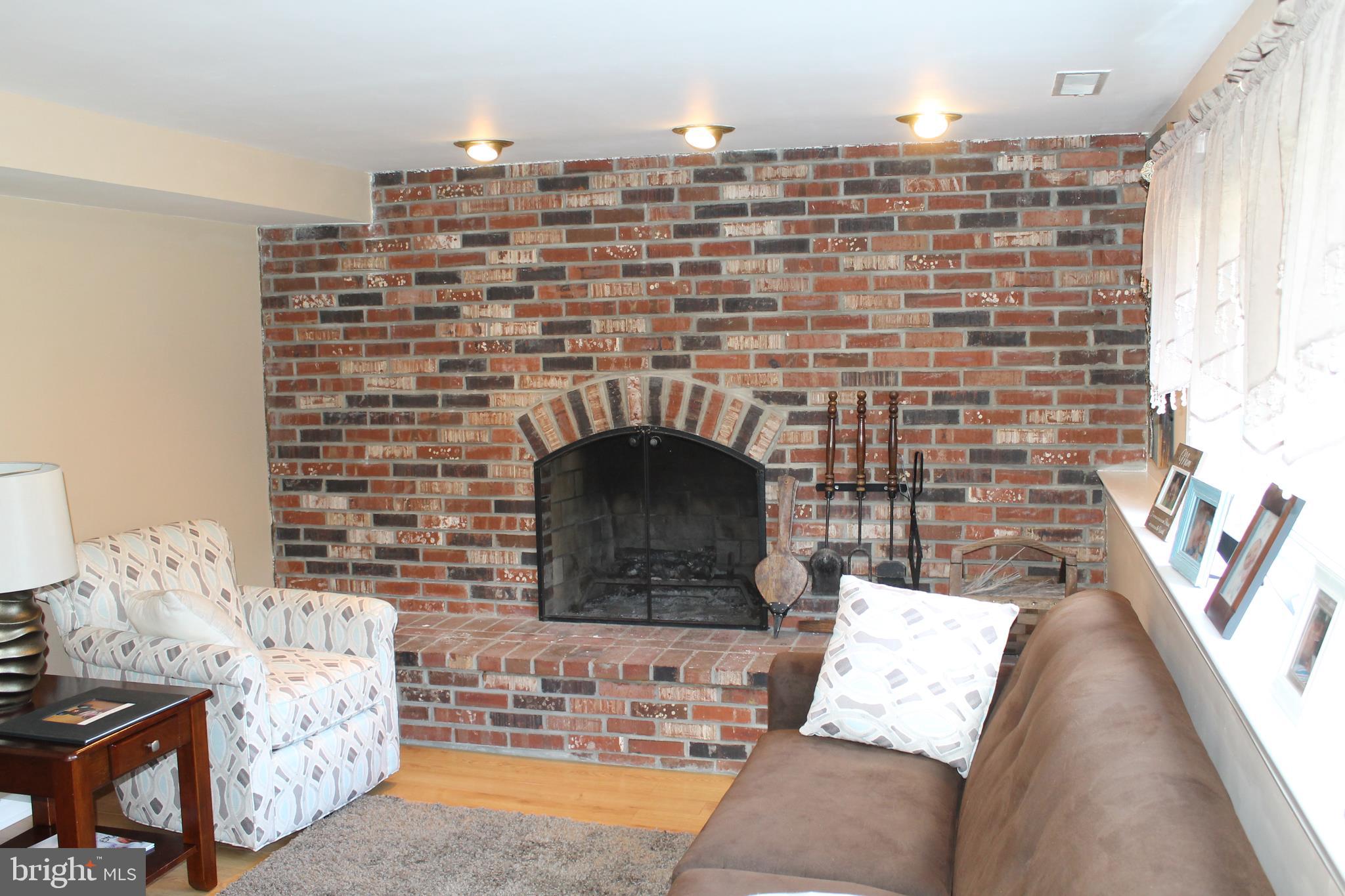 35 Overhill Road Stratford, NJ 08084 - Photo 3 of 43 a living room with furniture and a fireplace