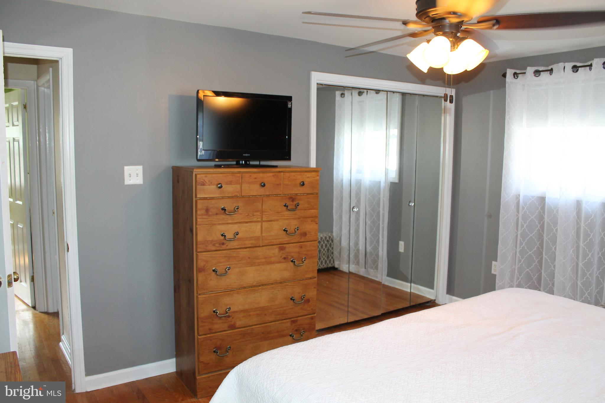 35 Overhill Road Stratford, NJ 08084 - Photo 21 of 43 a bedroom with a bed and a flat tv screen on dresser