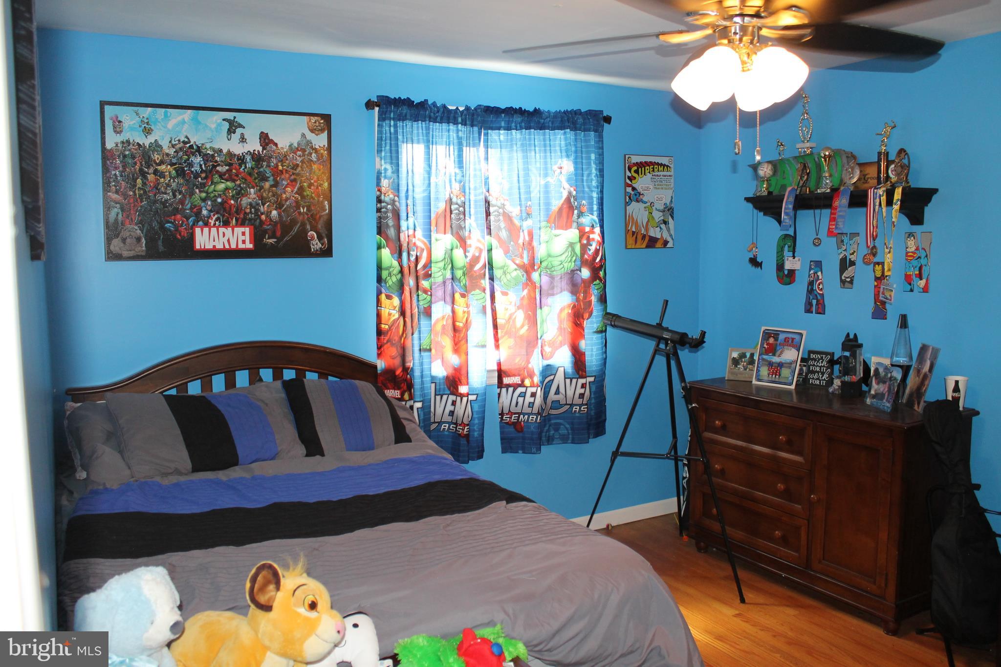 35 Overhill Road Stratford, NJ 08084 - Photo 22 of 43 a bedroom with a bed and a chandelier