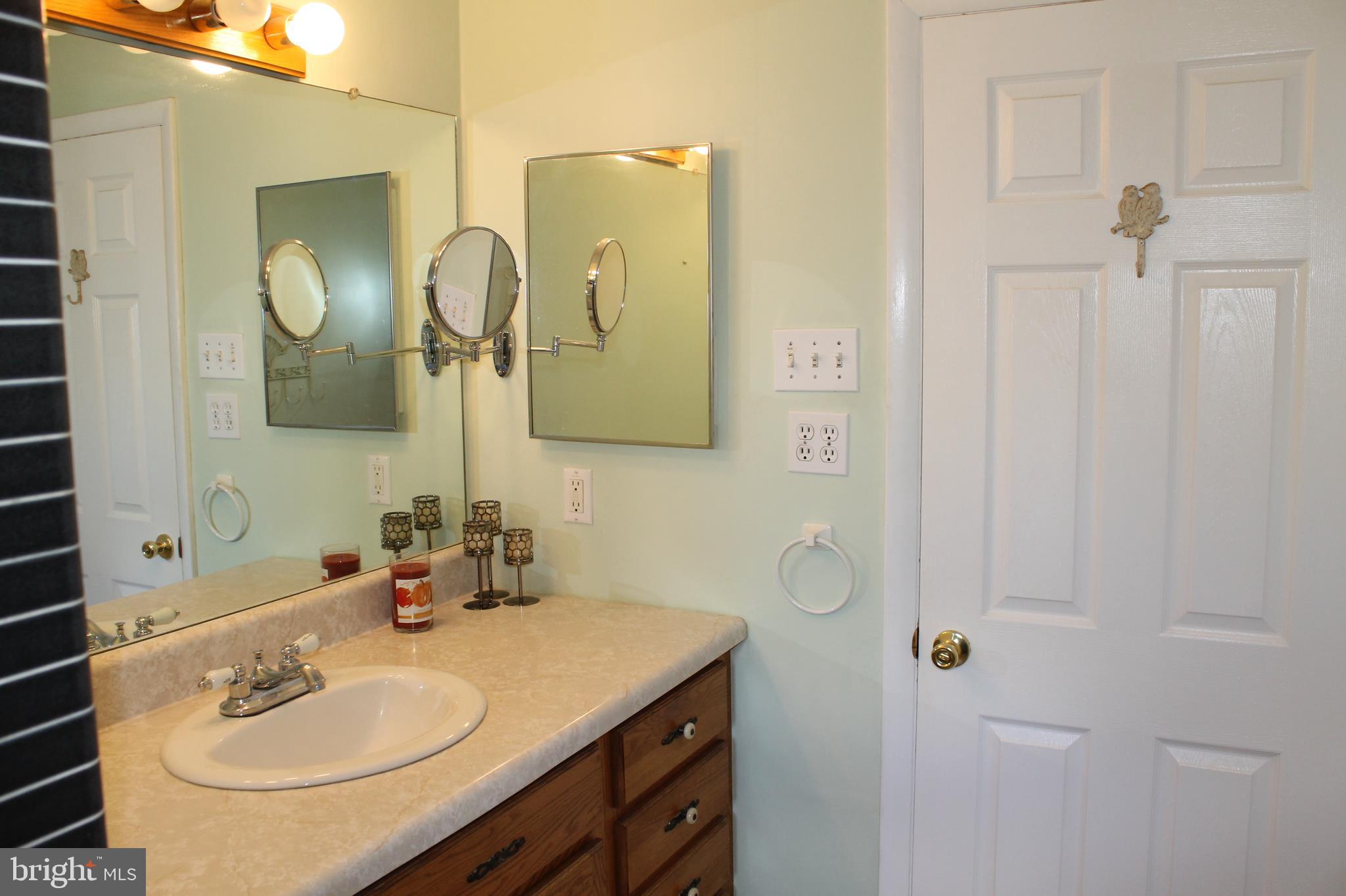 35 Overhill Road Stratford, NJ 08084 - Photo 30 of 43 a bathroom with a sink vanity and a mirror