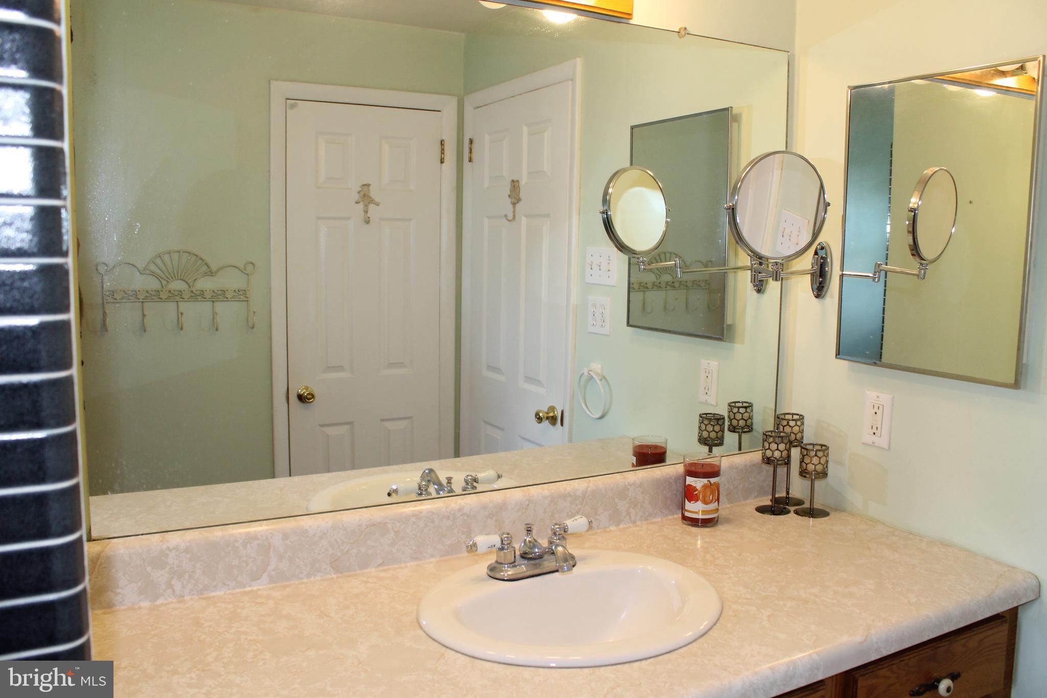 35 Overhill Road Stratford, NJ 08084 - Photo 31 of 43 a bathroom with a sink and a mirror