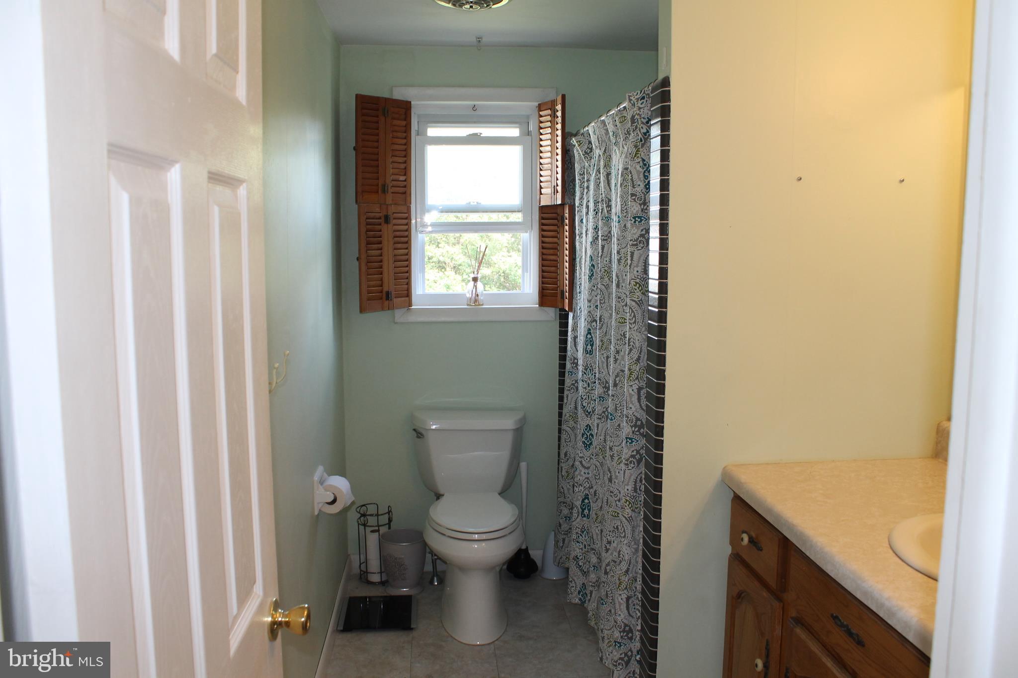35 Overhill Road Stratford, NJ 08084 - Photo 33 of 43 a bathroom with a granite countertop toilet a sink and a mirror