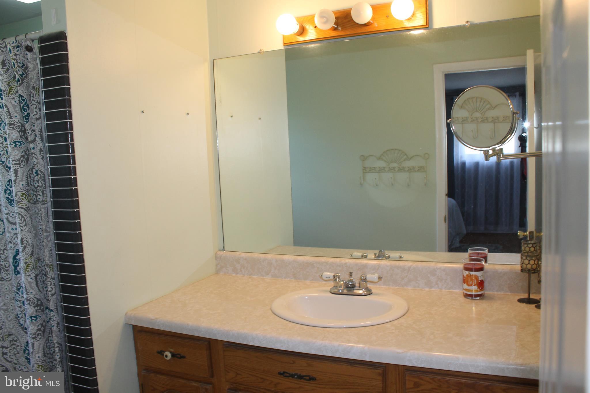 35 Overhill Road Stratford, NJ 08084 - Photo 38 of 43 a bathroom with a sink and a mirror
