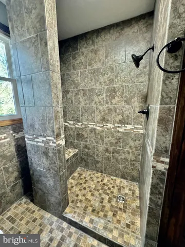 a bathroom with a granite countertop shower and a sink