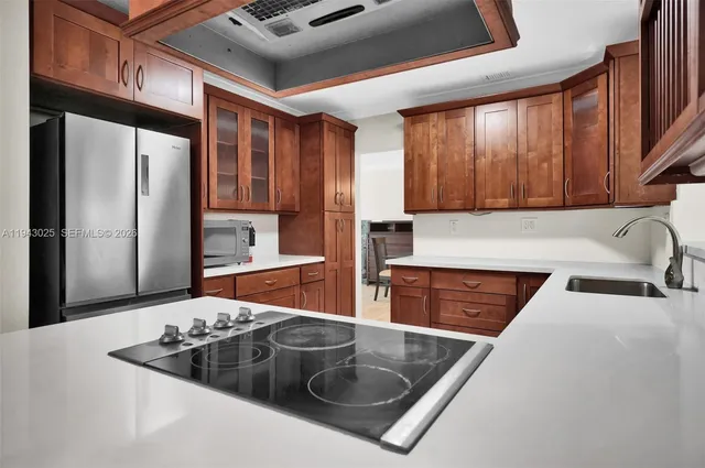 a kitchen with stainless steel appliances granite countertop a sink stove and refrigerator