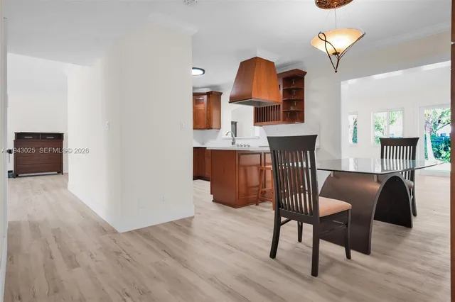 a view of a workspace with furniture and wooden floor