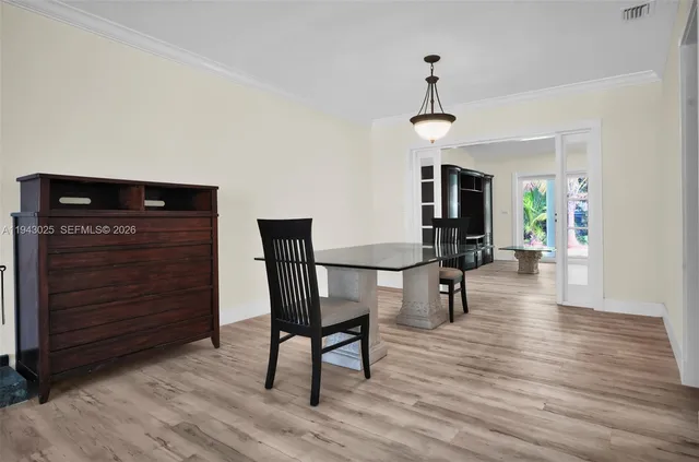 a view of a room with furniture and wooden floor
