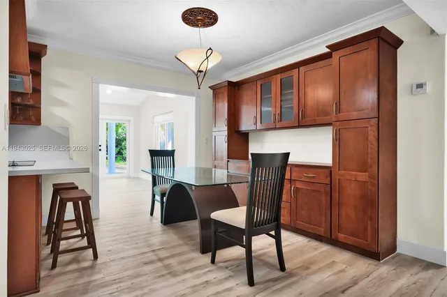 a dining room with furniture a chandelier and wooden floor