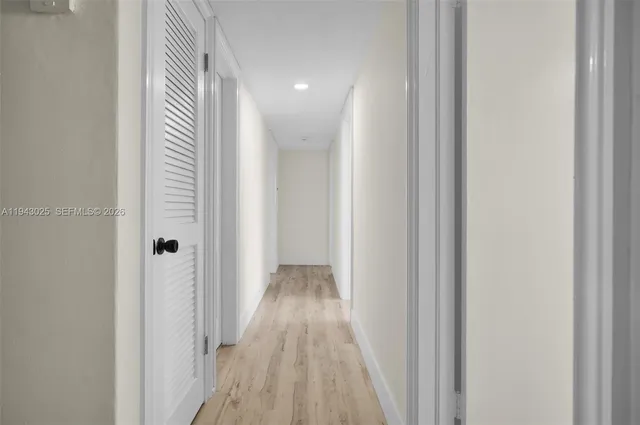 a view of a hallway with wooden floor