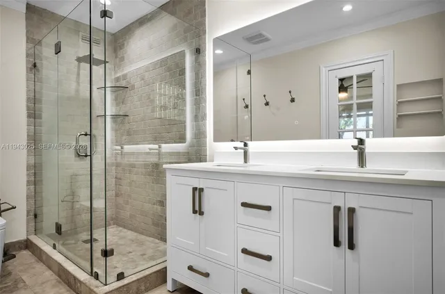 a bathroom with a shower sink and mirror