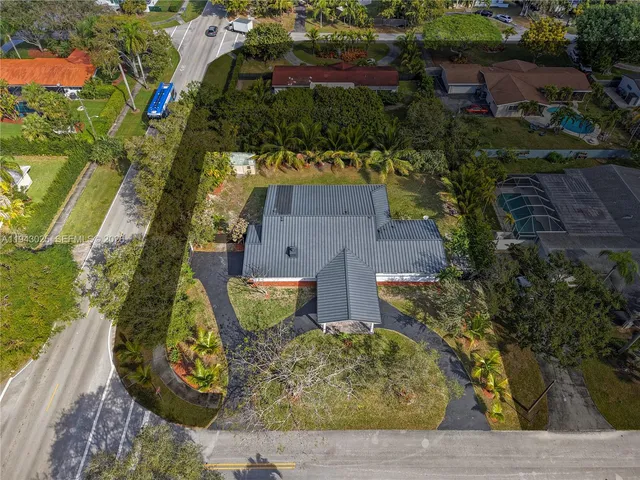 an aerial view of a house with a yard