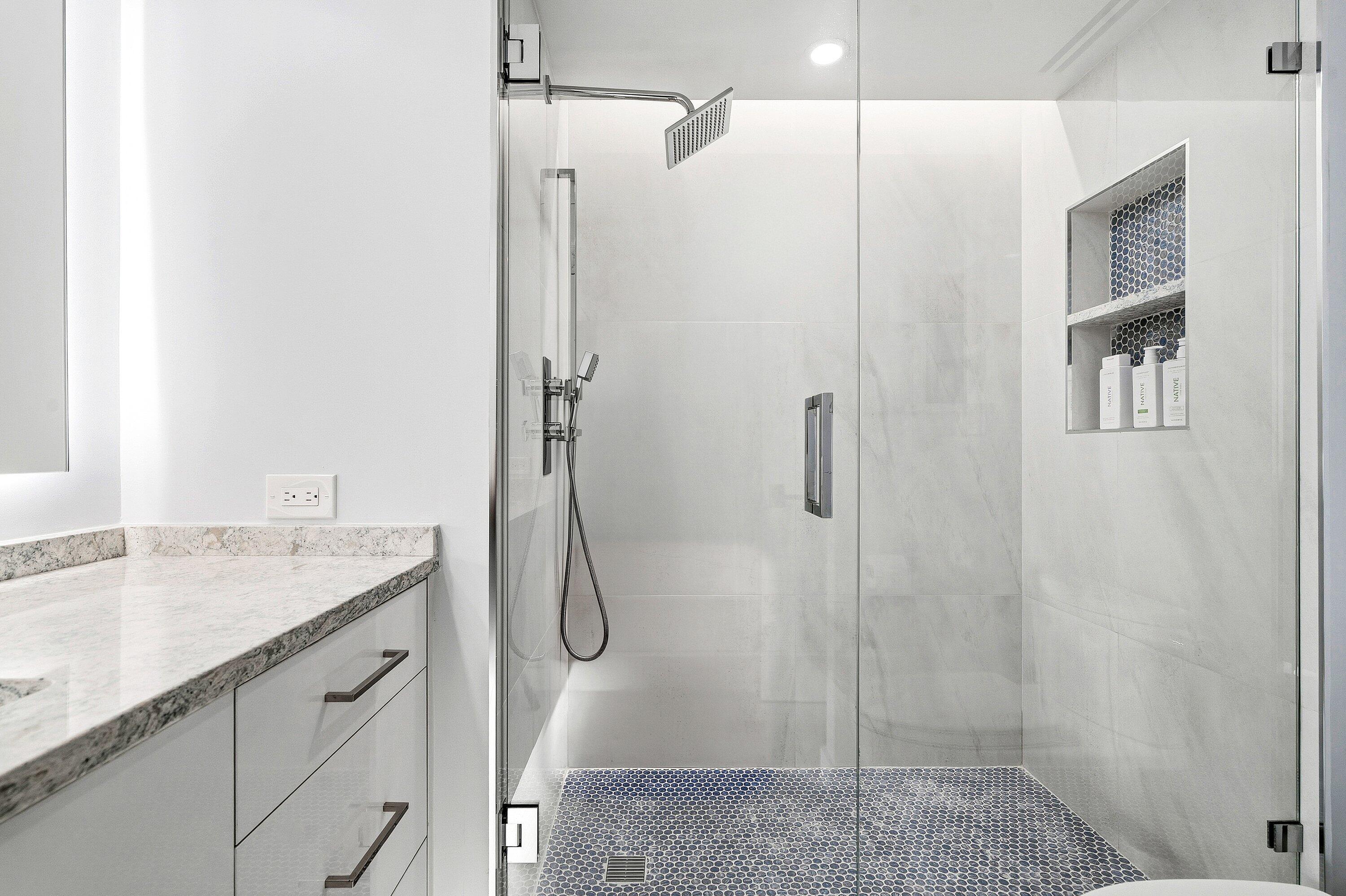 500 South Ocean Boulevard, Unit 801 Boca Raton, FL 33432 - Photo 21 of 61 a bathroom with a granite countertop shower sink vanity and mirror