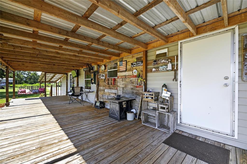4416 Pippin Road Plant City, FL 33567 - Photo 12 of 86 a view of a patio with table and chairs with wooden floor