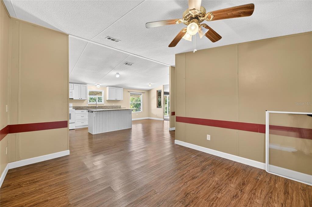 4416 Pippin Road Plant City, FL 33567 - Photo 27 of 86 a view of a kitchen with wooden floor and a kitchen space
