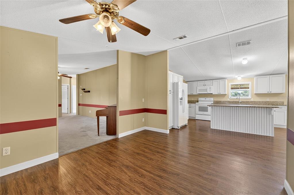 4416 Pippin Road Plant City, FL 33567 - Photo 28 of 86 a view of kitchen with cabinets and wooden floor