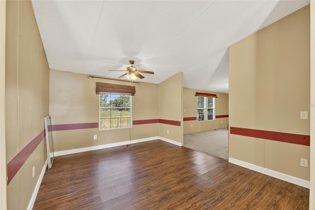 4416 Pippin Road Plant City, FL 33567 - Photo 29 of 86 a view of empty room with wooden floor and fan