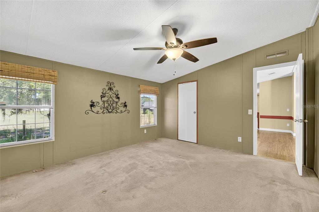 4416 Pippin Road Plant City, FL 33567 - Photo 38 of 86 a view of a big room with a chandelier fan and windows