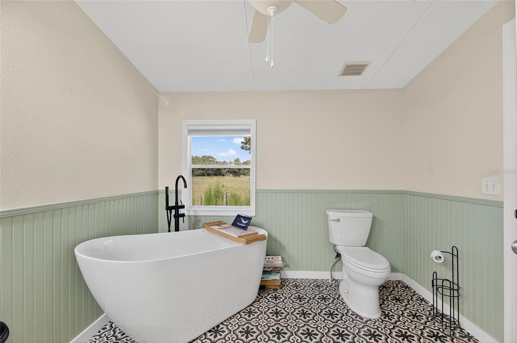 4416 Pippin Road Plant City, FL 33567 - Photo 40 of 86 a bathroom with a sink a toilet and a mirror