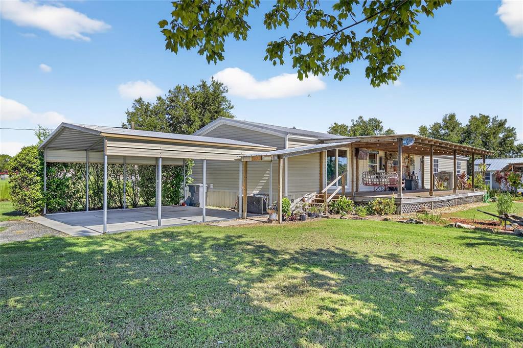 4416 Pippin Road Plant City, FL 33567 - Photo 5 of 86 a front view of a house with a yard table and chairs