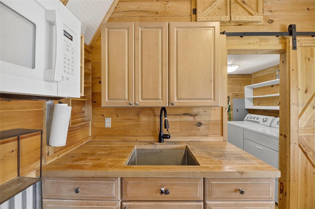 4416 Pippin Road Plant City, FL 33567 - Photo 55 of 86 a kitchen with granite countertop white cabinets and sink