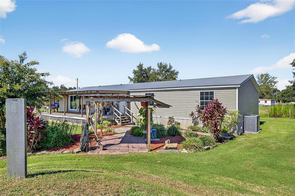 4416 Pippin Road Plant City, FL 33567 - Photo 7 of 86 a view of a porch with a table and chairs