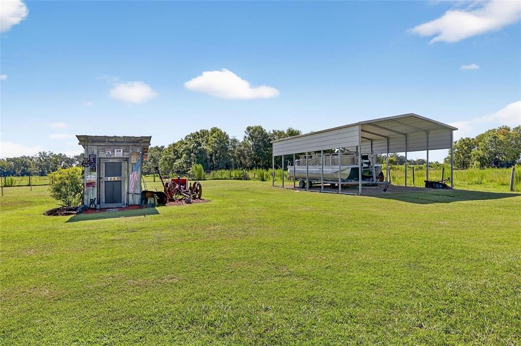 4416 Pippin Road Plant City, FL 33567 - Photo 8 of 86 a view of a house with a big yard and potted plants