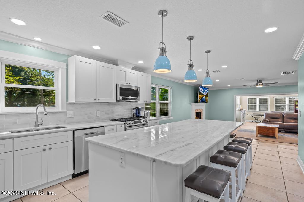 14340 Stacey Road Jacksonville, FL 32250 - Photo 11 of 54 a kitchen with counter top space appliances and a window