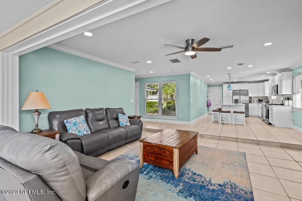 14340 Stacey Road Jacksonville, FL 32250 - Photo 16 of 54 a living room with furniture and a chandelier