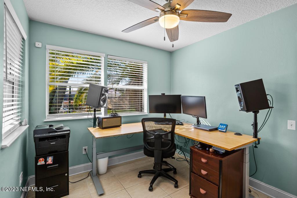 14340 Stacey Road Jacksonville, FL 32250 - Photo 28 of 54 a view of a workspace with furniture and a window