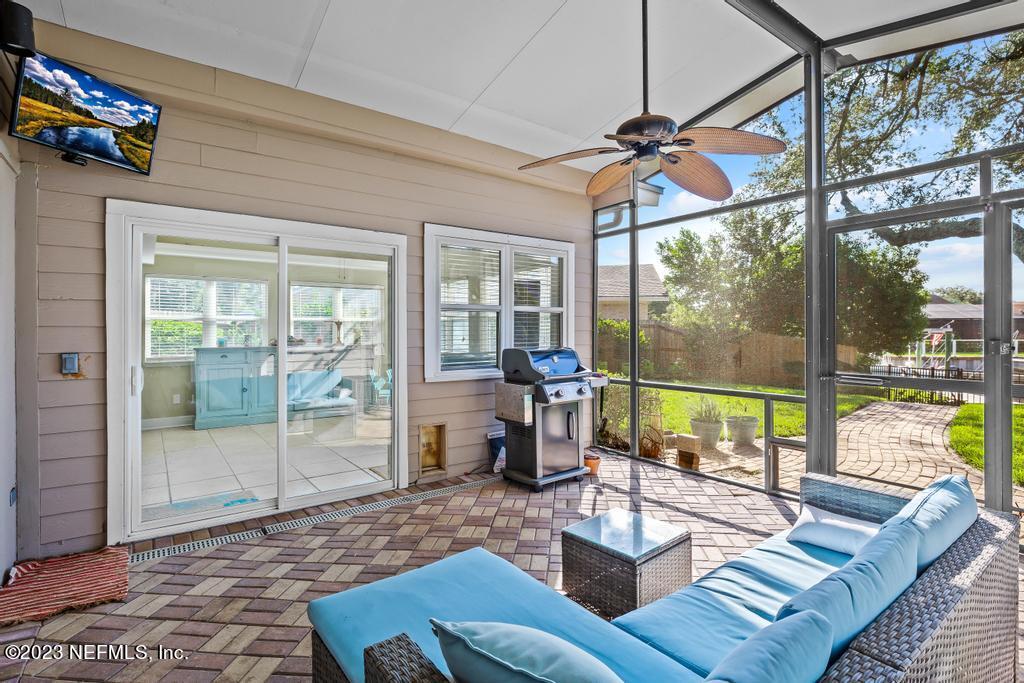 14340 Stacey Road Jacksonville, FL 32250 - Photo 34 of 54 a living room with furniture and a floor to ceiling window