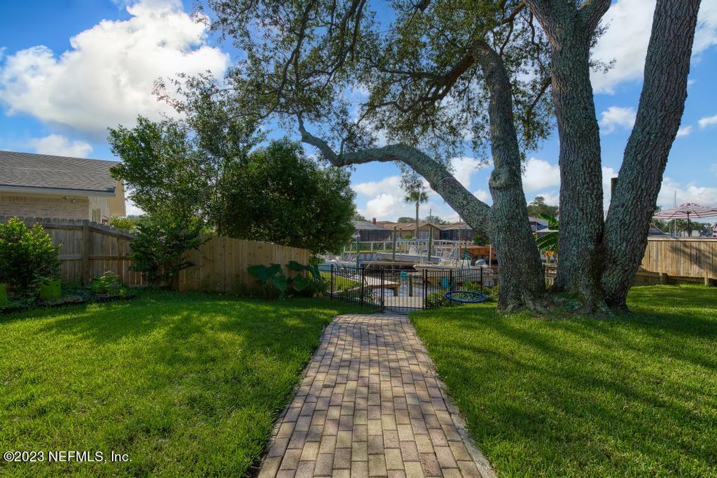 14340 Stacey Road Jacksonville, FL 32250 - Photo 35 of 54 a front view of a house with garden