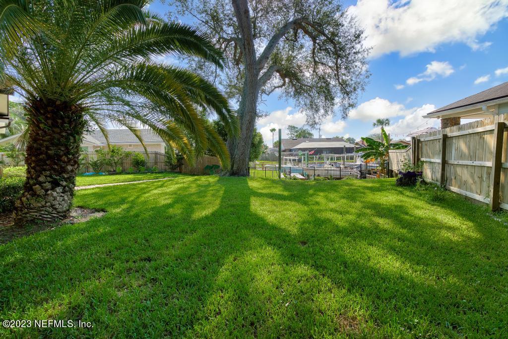 14340 Stacey Road Jacksonville, FL 32250 - Photo 44 of 54 a view of a house with a yard