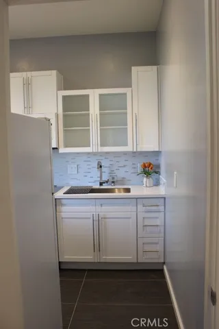 a kitchen with a sink and cabinets