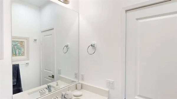 a bathroom with a granite countertop sink a toilet and shower