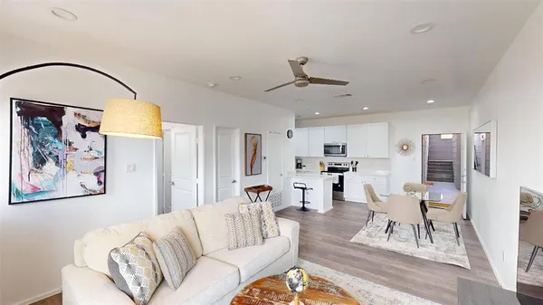 a living room with furniture and kitchen view