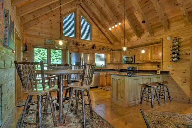 a large kitchen with a table and chairs