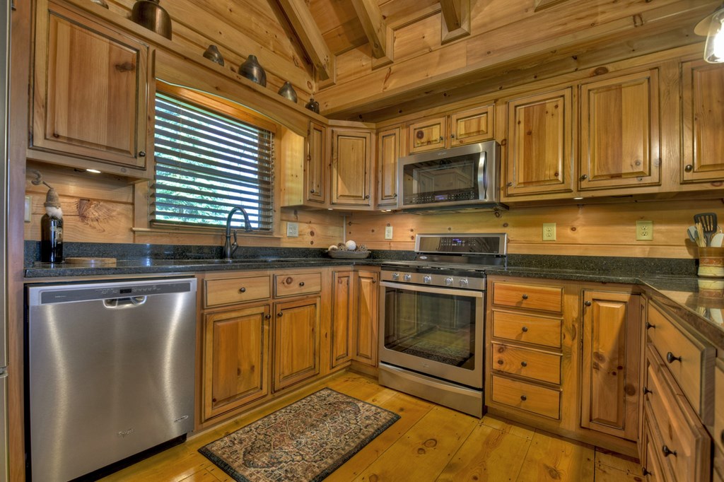 783 North Moreland Drive North Blue Ridge, GA 30513 - Photo 45 of 54 a kitchen with stainless steel appliances granite countertop a stove a sink and a microwave