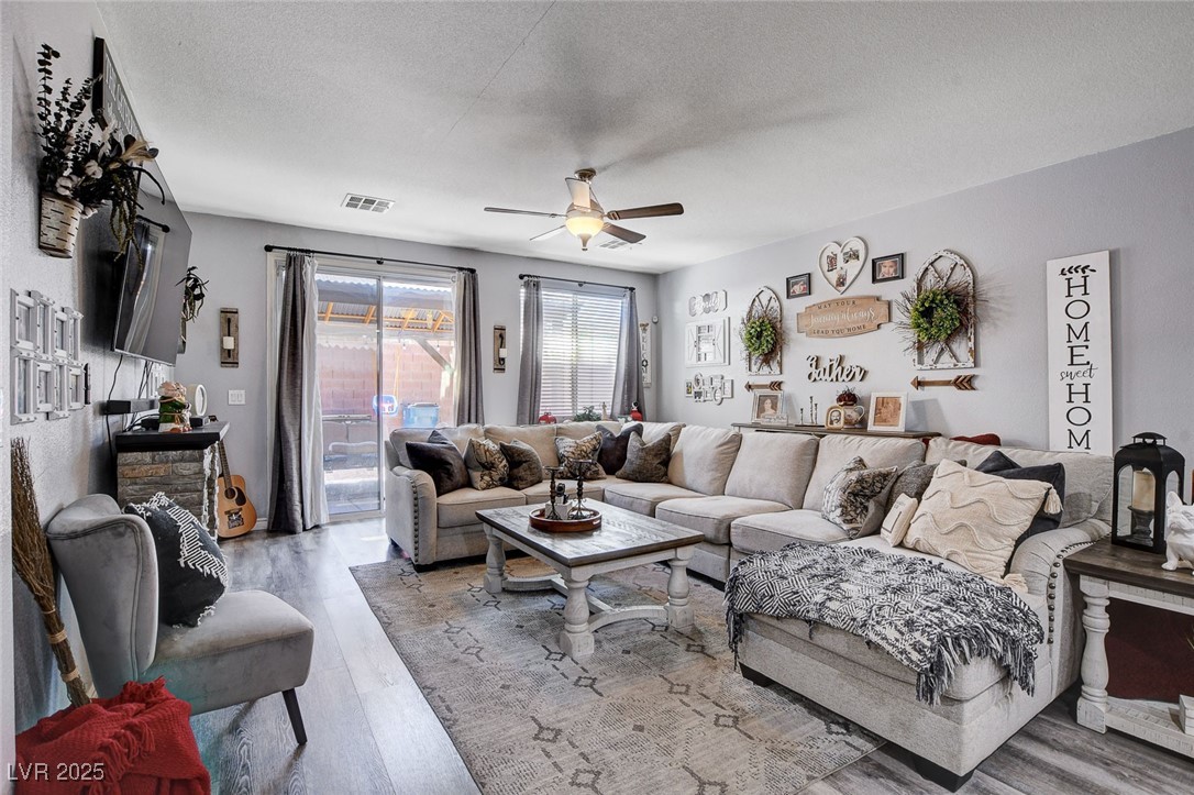 5929 North Caddy Ridge Street North Las Vegas, NV 89031 - Photo 15 of 37 Living room featuring wood finished floors, a textured ceiling, and a ceiling fan