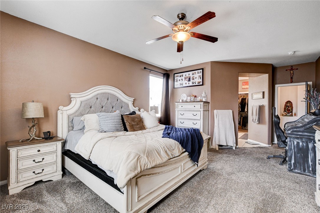 5929 North Caddy Ridge Street North Las Vegas, NV 89031 - Photo 19 of 37 Bedroom with carpet, a walk in closet, a ceiling fan, and a desk