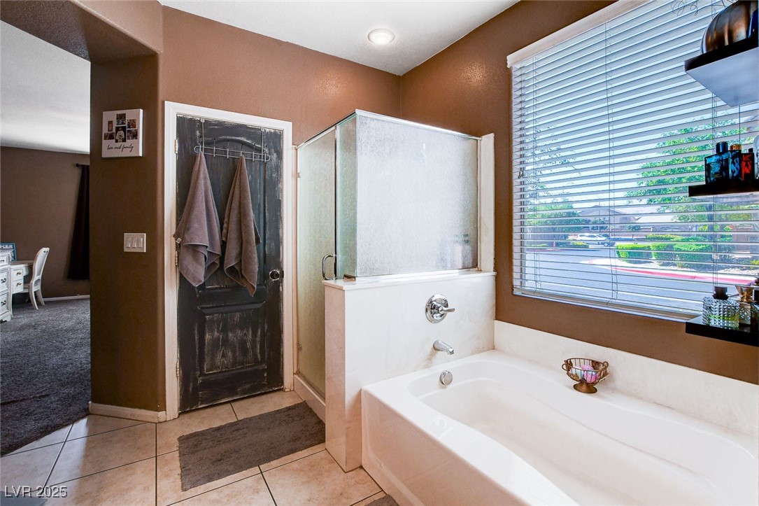 5929 North Caddy Ridge Street North Las Vegas, NV 89031 - Photo 22 of 37 Full bathroom with a bath, a stall shower, and tile patterned flooring