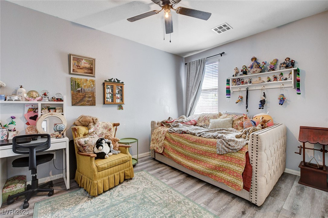 5929 North Caddy Ridge Street North Las Vegas, NV 89031 - Photo 25 of 37 Bedroom with wood finished floors, a ceiling fan, and an office area