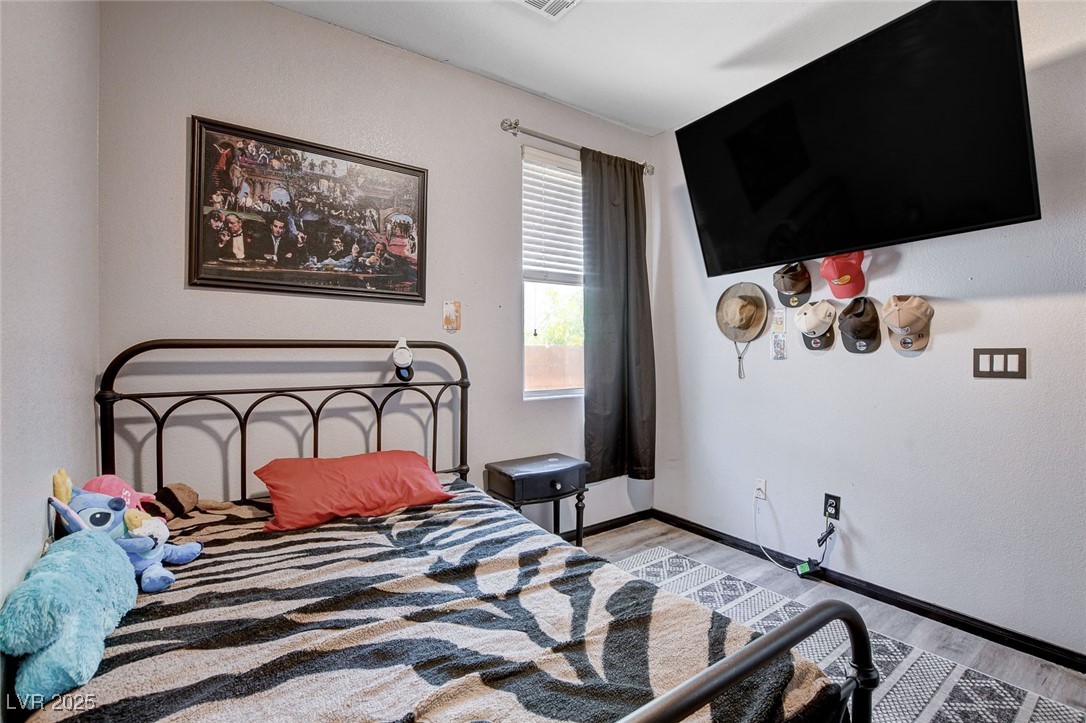 5929 North Caddy Ridge Street North Las Vegas, NV 89031 - Photo 31 of 37 Bedroom featuring wood finished floors and baseboards