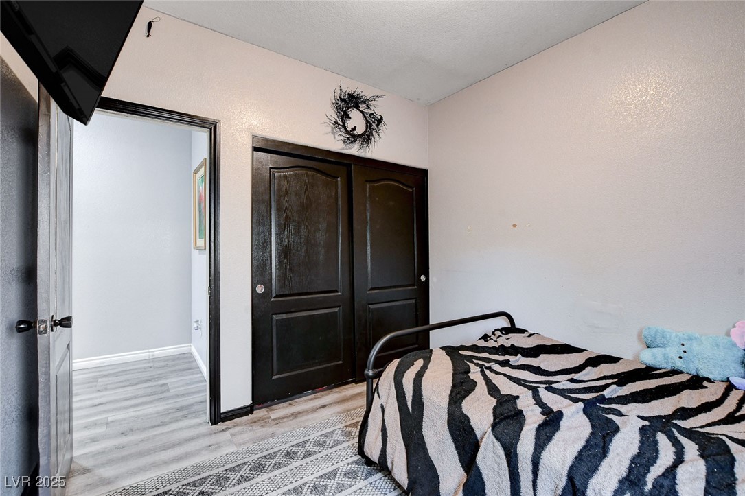 5929 North Caddy Ridge Street North Las Vegas, NV 89031 - Photo 32 of 37 Bedroom with light wood-style flooring and baseboards